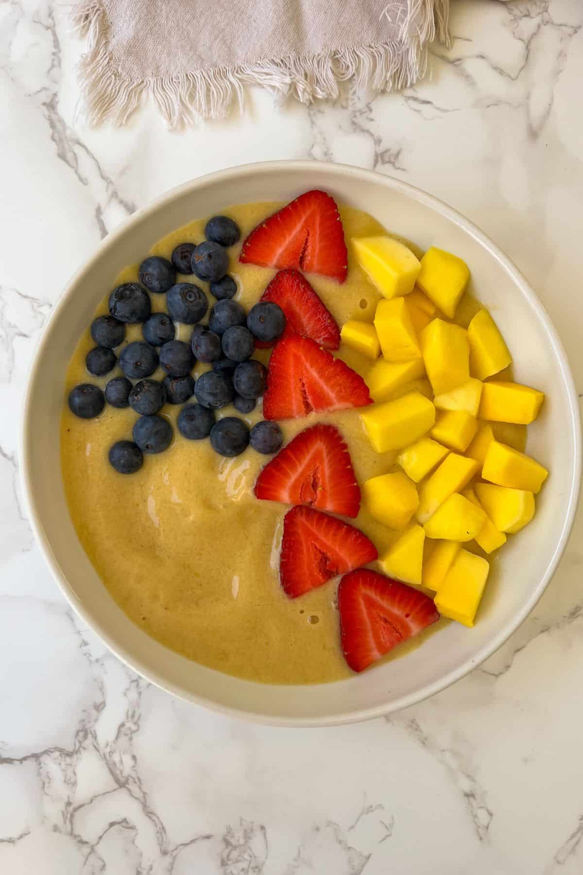 mango smoothie bowl with fruit toppings