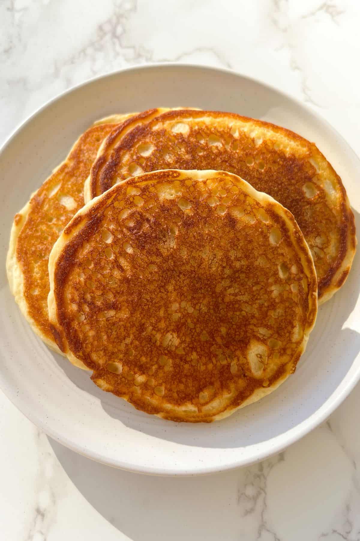 stack of buttermilk protein pancakes with whipped cinnamon honey butter