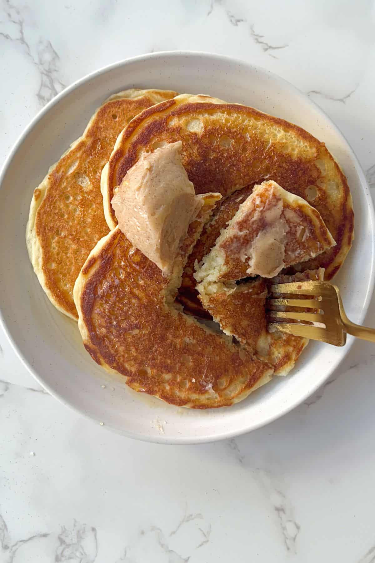 stack of buttermilk protein pancakes with butter and syrup