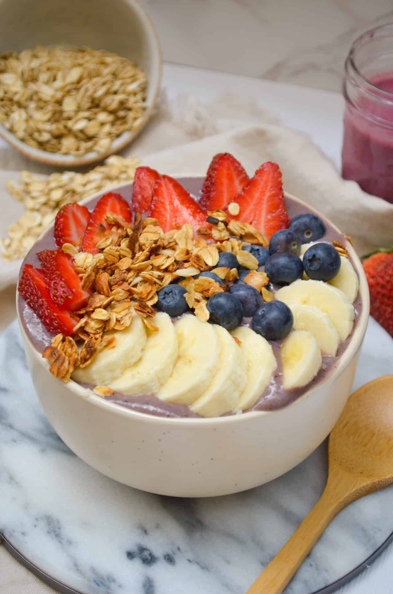 easy protein acai bowl - feasty travels