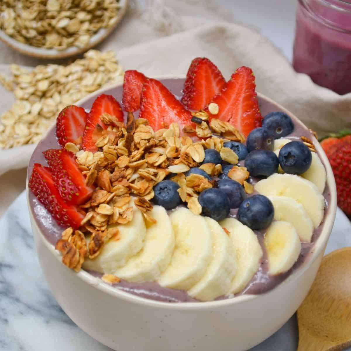 protein smoothie bowl topped with fruit and granola