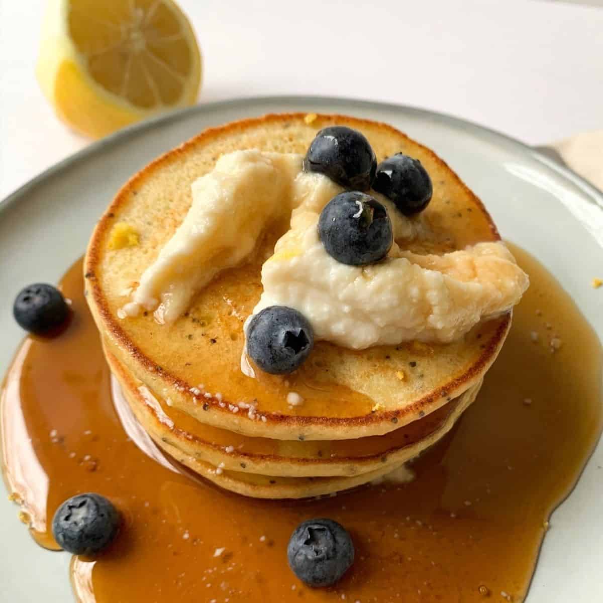 lemon pancakes with whipped honey ricotta and maple syrup pour