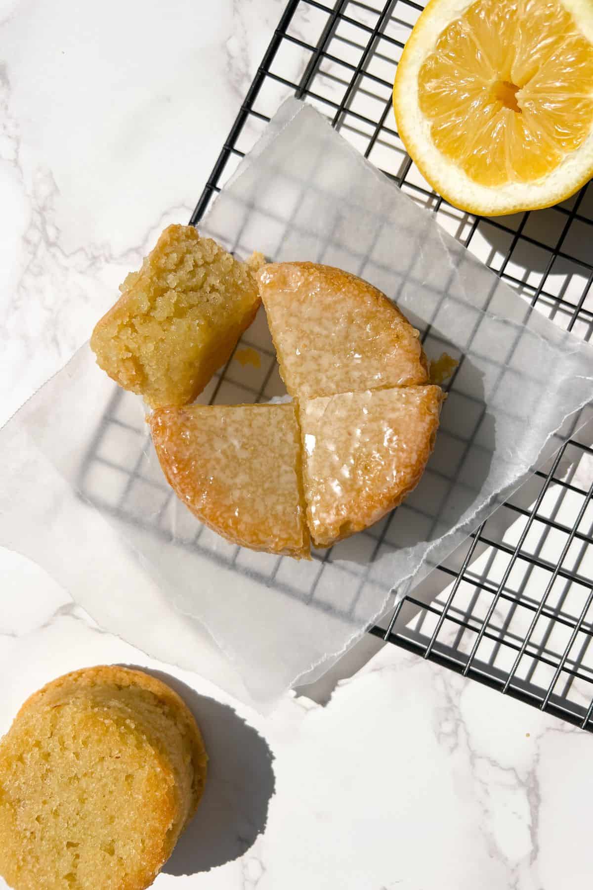 Sliced vegan olive oil cake on a cooling rack.