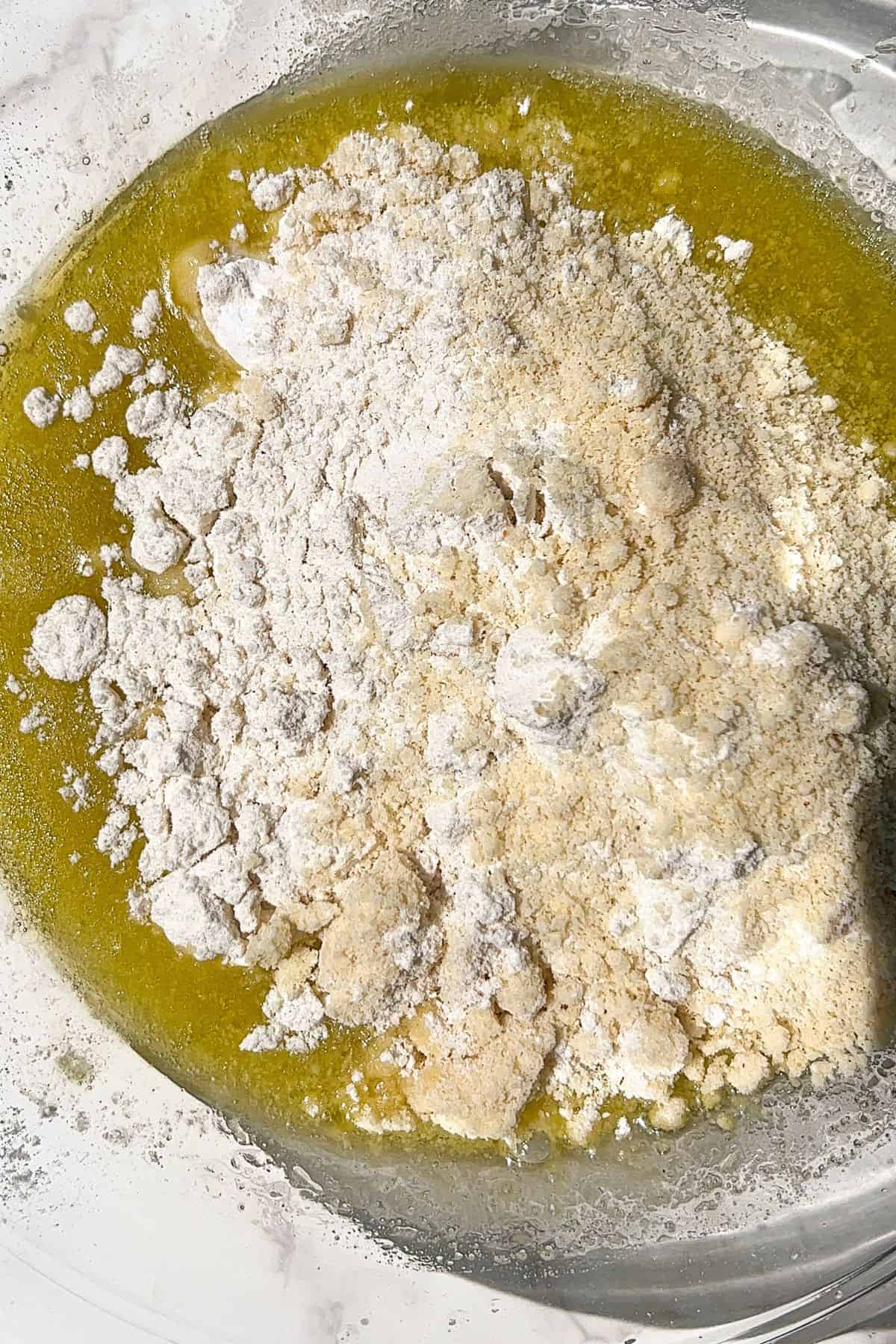Add the dry ingredients to the olive oil cake batter.