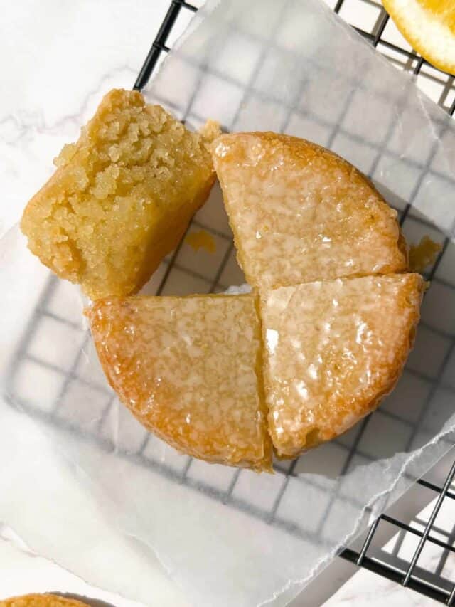 Vegan Olive Oil Cake Topped with a glaze and sliced.