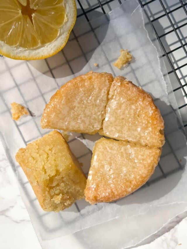 Sliced Vegan Olive Oil Cake topped with a glaze and sliced.