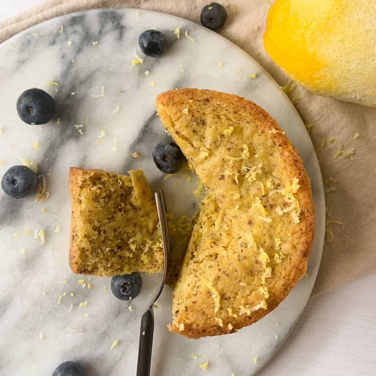 lemon olive oil cake with a piece being taken off