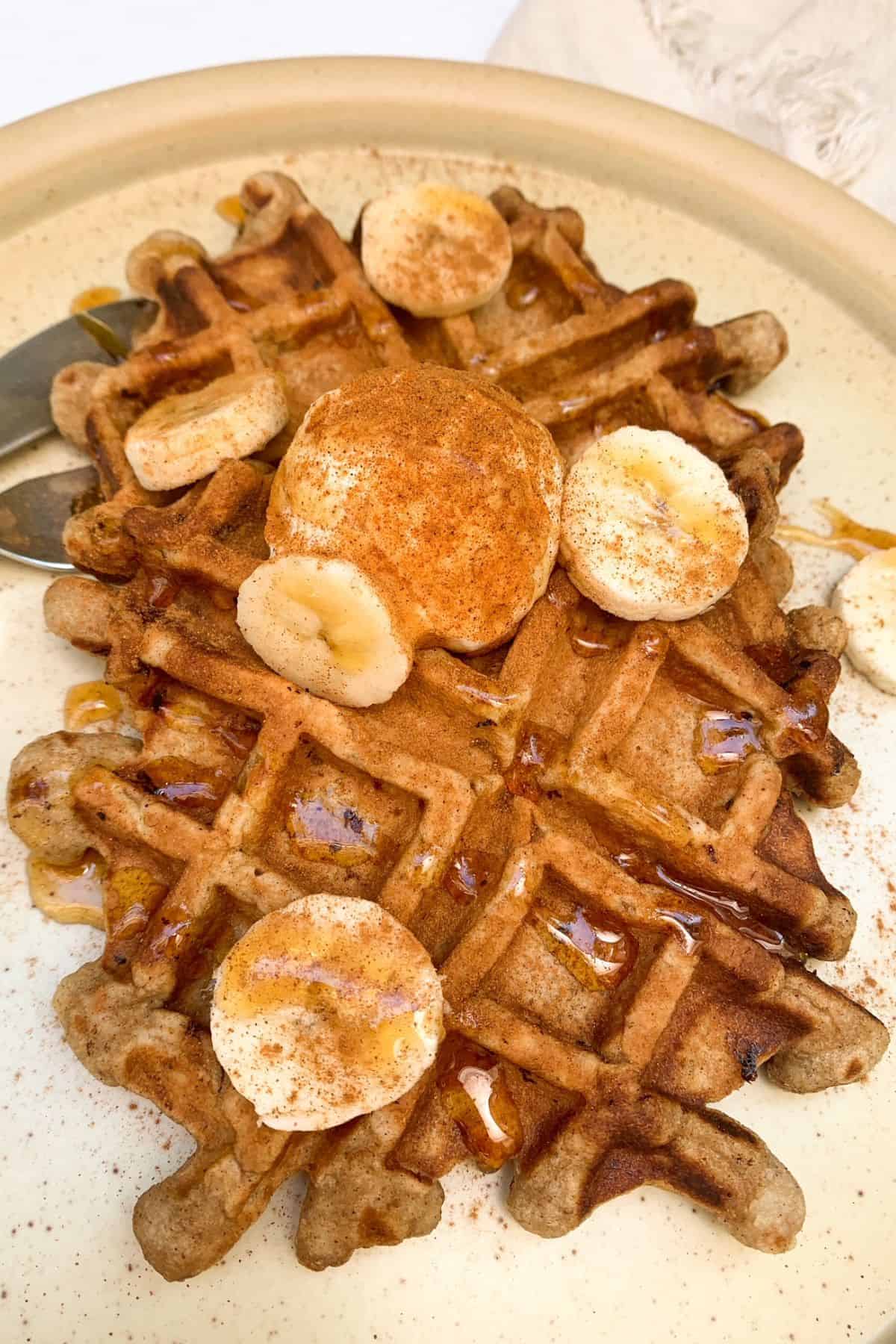 Two Single Serving Waffles on a plate with toppings.