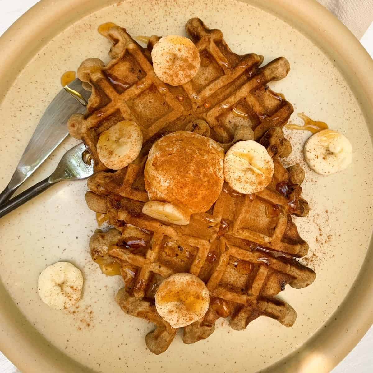 healthy protein banana waffle topped with greek yogurt, cinnamon, bananas and honey