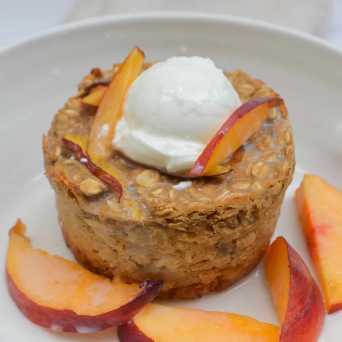peaches and cream baked oatmeal topped with greek yogurt and plant milk