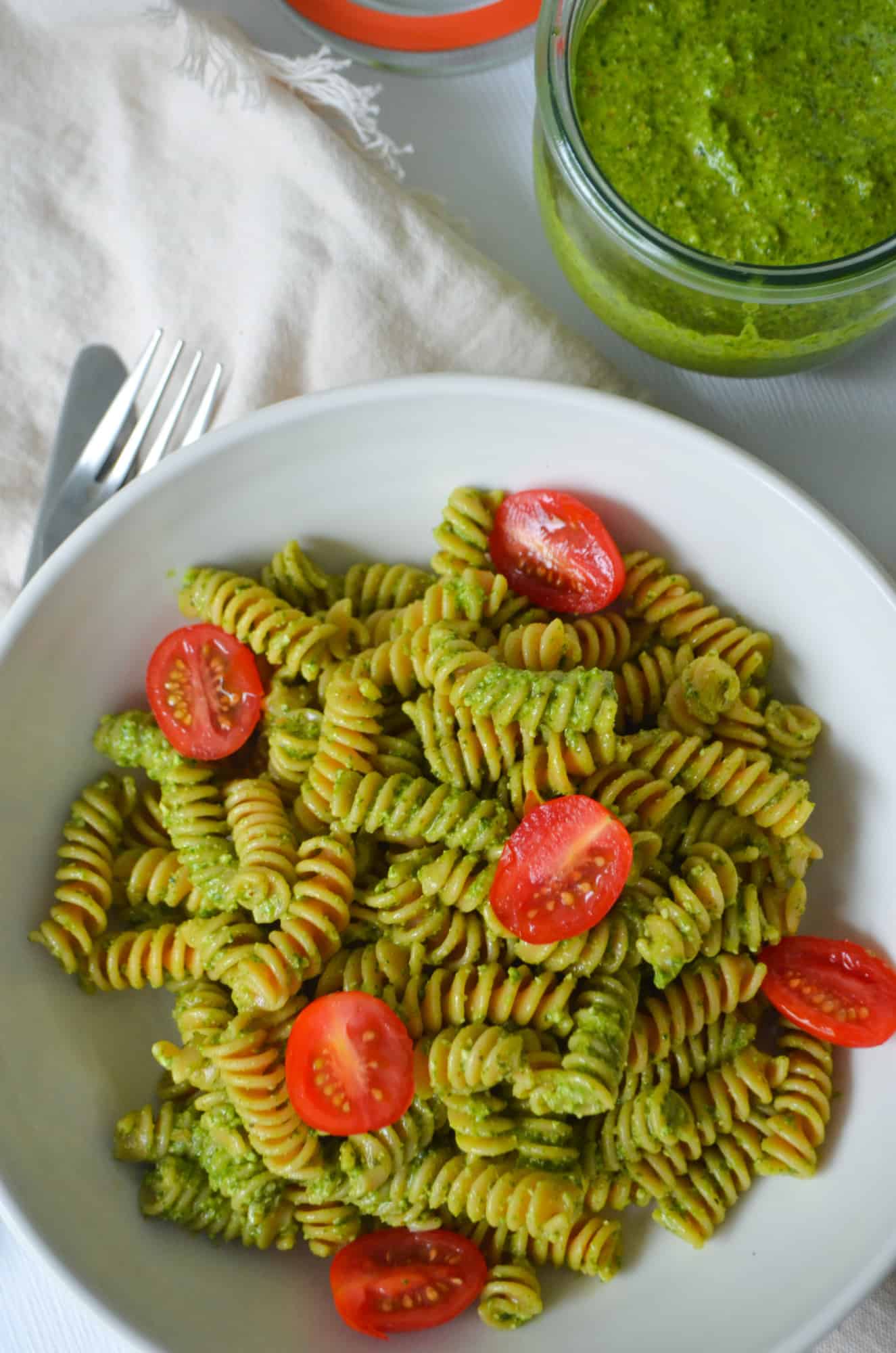 Spinach Pesto Sauce paired with pasta and fresh tomatoes.