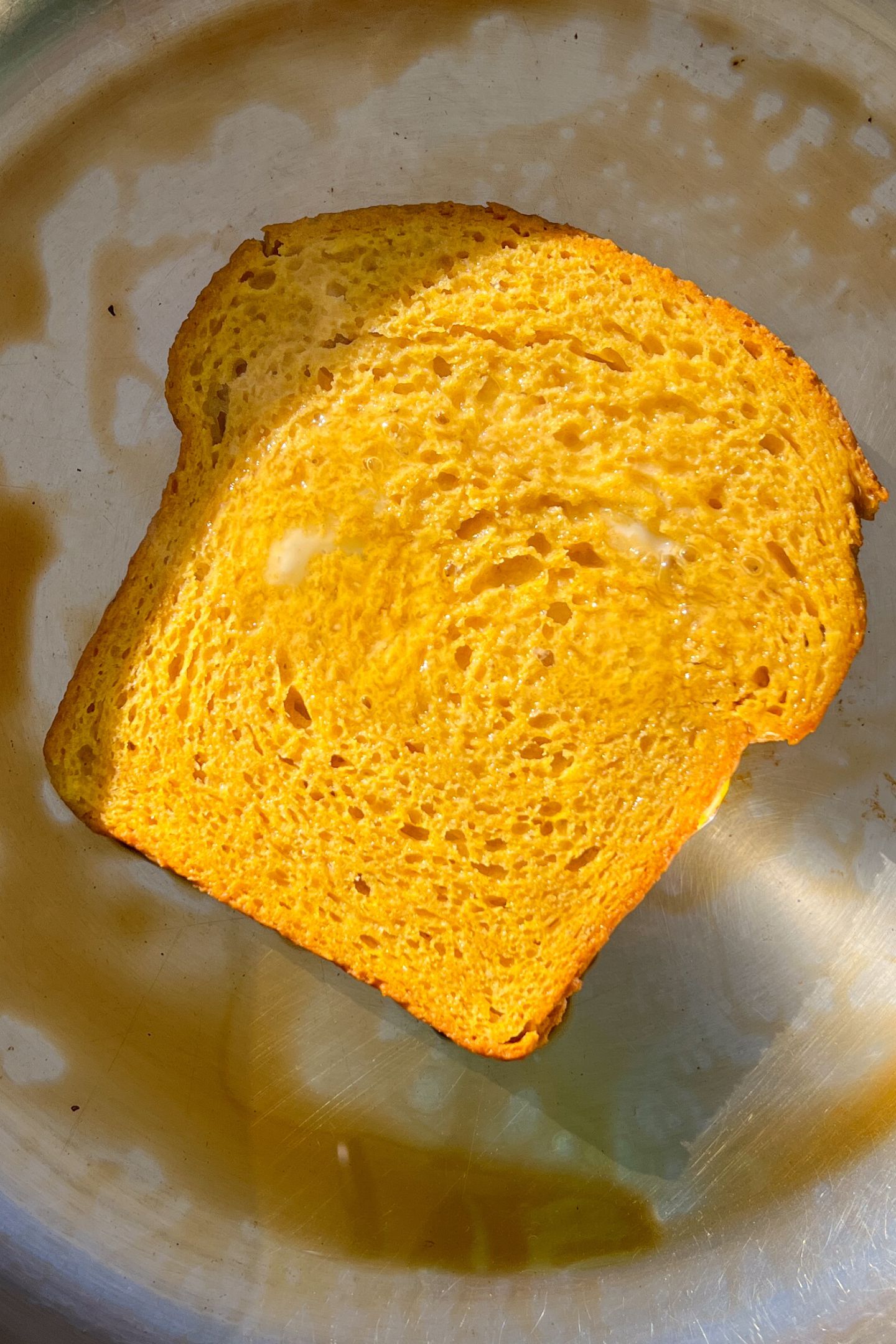 Slice of soaked bread in a heated pan.