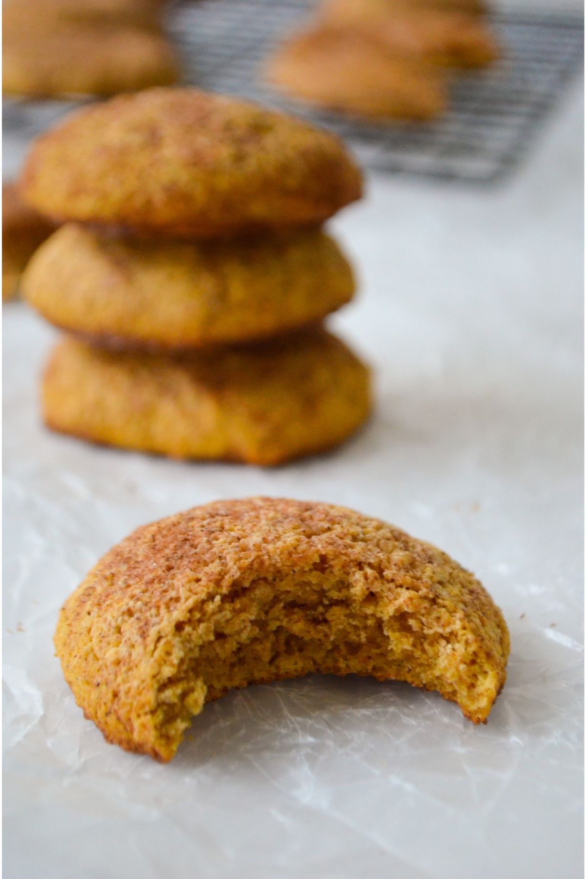 Pumpkin snickerdoodle cookie with a bite taken out of it