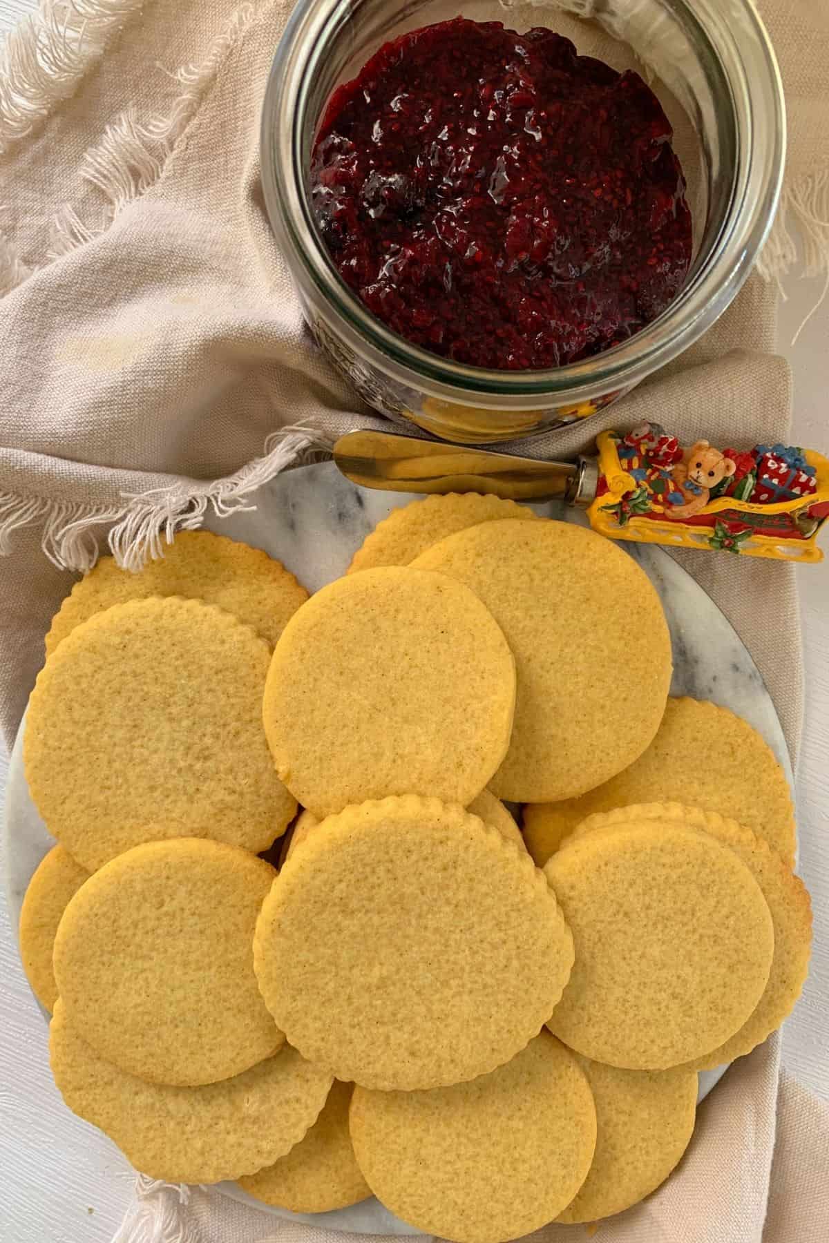 shortbread cookies on a plate and chia seed jam in a mason jar