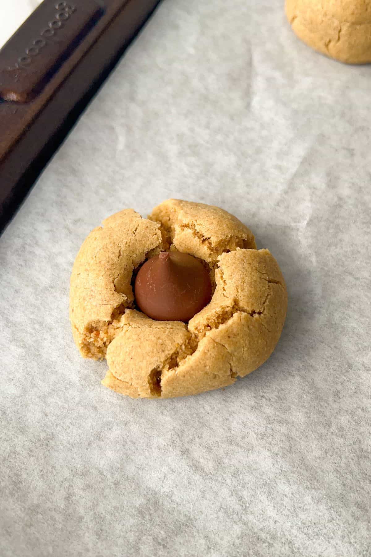 baked gluten-free peanut butter blossoms with hershey kiss in the center