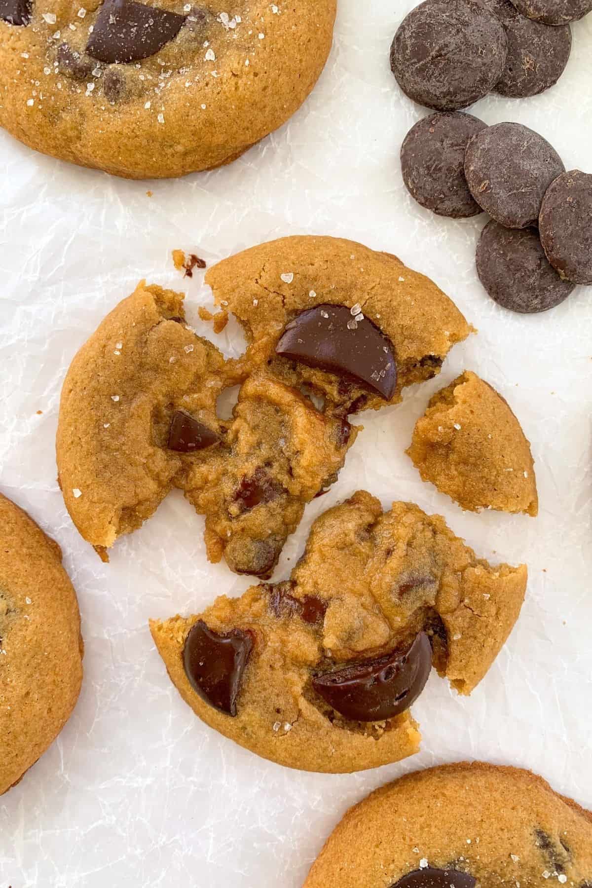 Chocolate Chunk Cookies with Sea Salt broken apart and gooey in the center.
