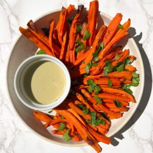 Crispy Carrot Fries in a bowl with dipping sauce.