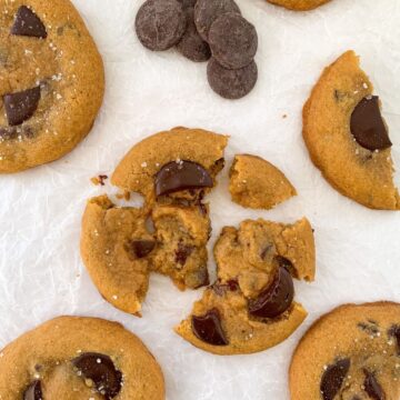 chocolate sea salt cookies with one broken apart in the middle