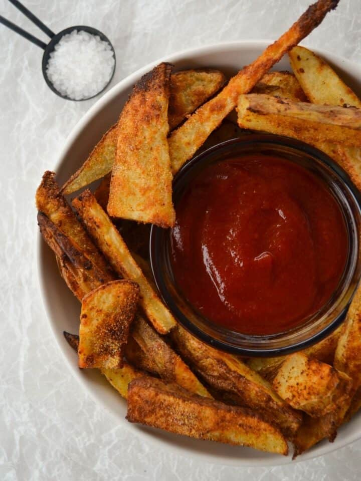 roasted potato wedges in a bowl with ketchup