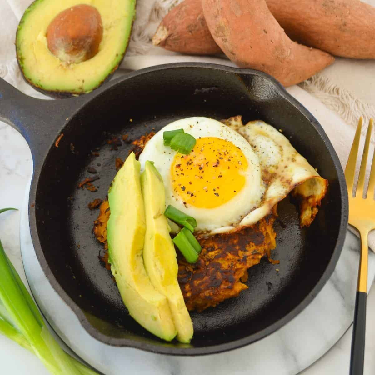 sweet potato hash topped with avocado and an egg