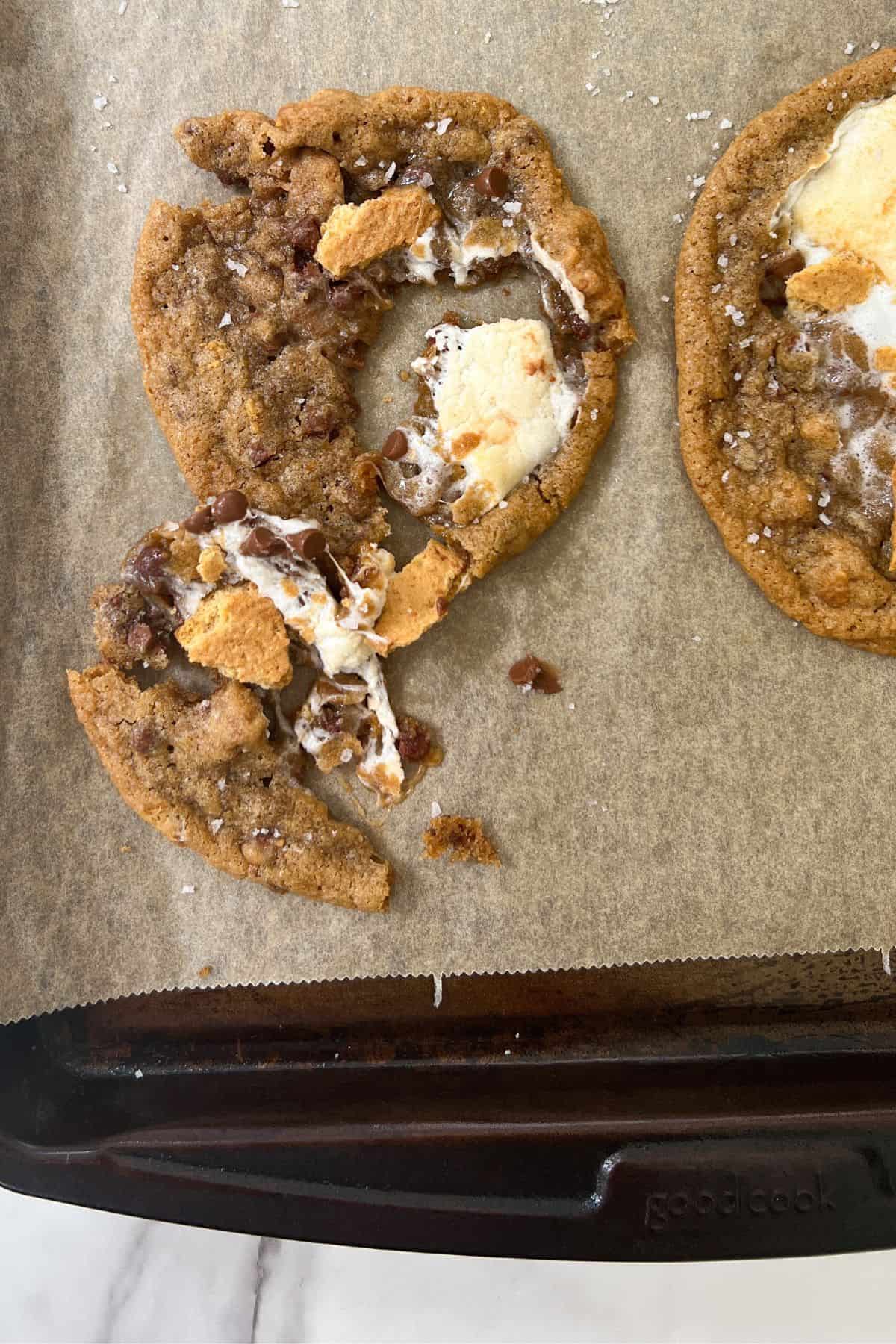 Broken up Chocolate Chip Marshmallow Cookies on a baking sheet.
