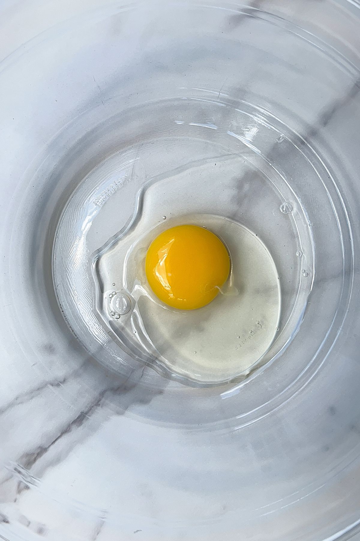 Egg in a large glass bowl to make Mini Chocolate cake.