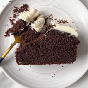 Eating a slice of Mini Chocolate Cake with Cream Cheese Frosting with a fork.