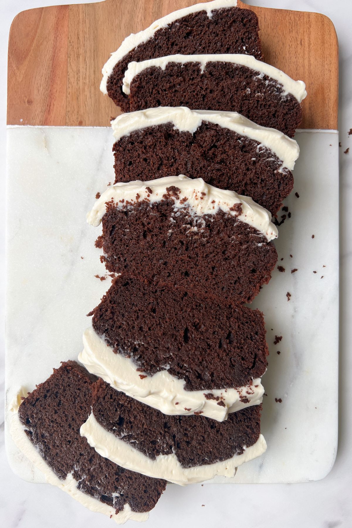 Slices of mini chocolate cake with cream cheese frosting.