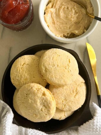 keto biscuits on a plate with jam and whipped honey butter