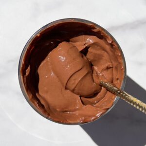 Scooping Chocolate Protein Mousse with a spoon.