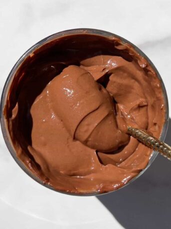 Scooping Chocolate Protein Mousse with a spoon.