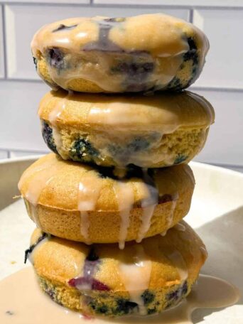 Stack of Glazed Blueberry Cake Donuts.
