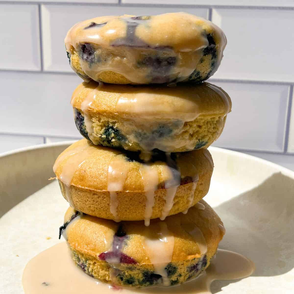 Stack of Glazed Blueberry Cake Donuts.