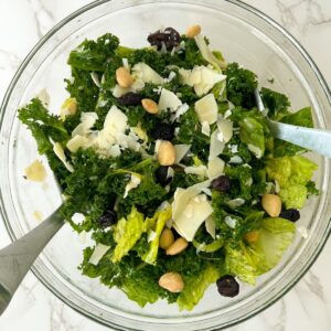 chopped kale salad with toppings in a big bowl