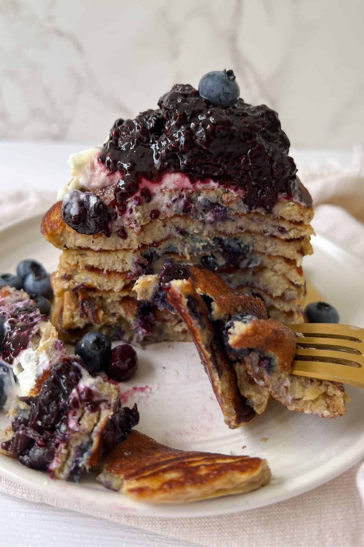 Stack of low calorie pancakes recipe without milk with slices taken out.