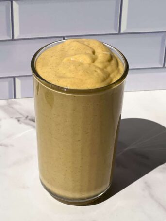 Mango Protein Smoothie poured in a glass.