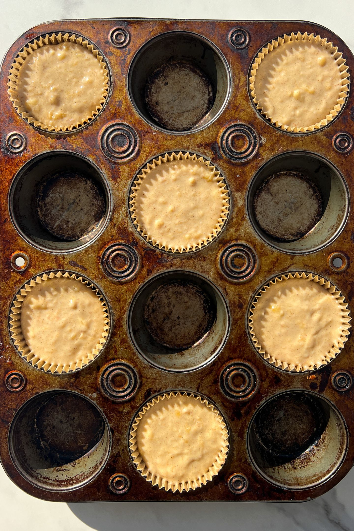 Banana muffin batter in muffin liners.