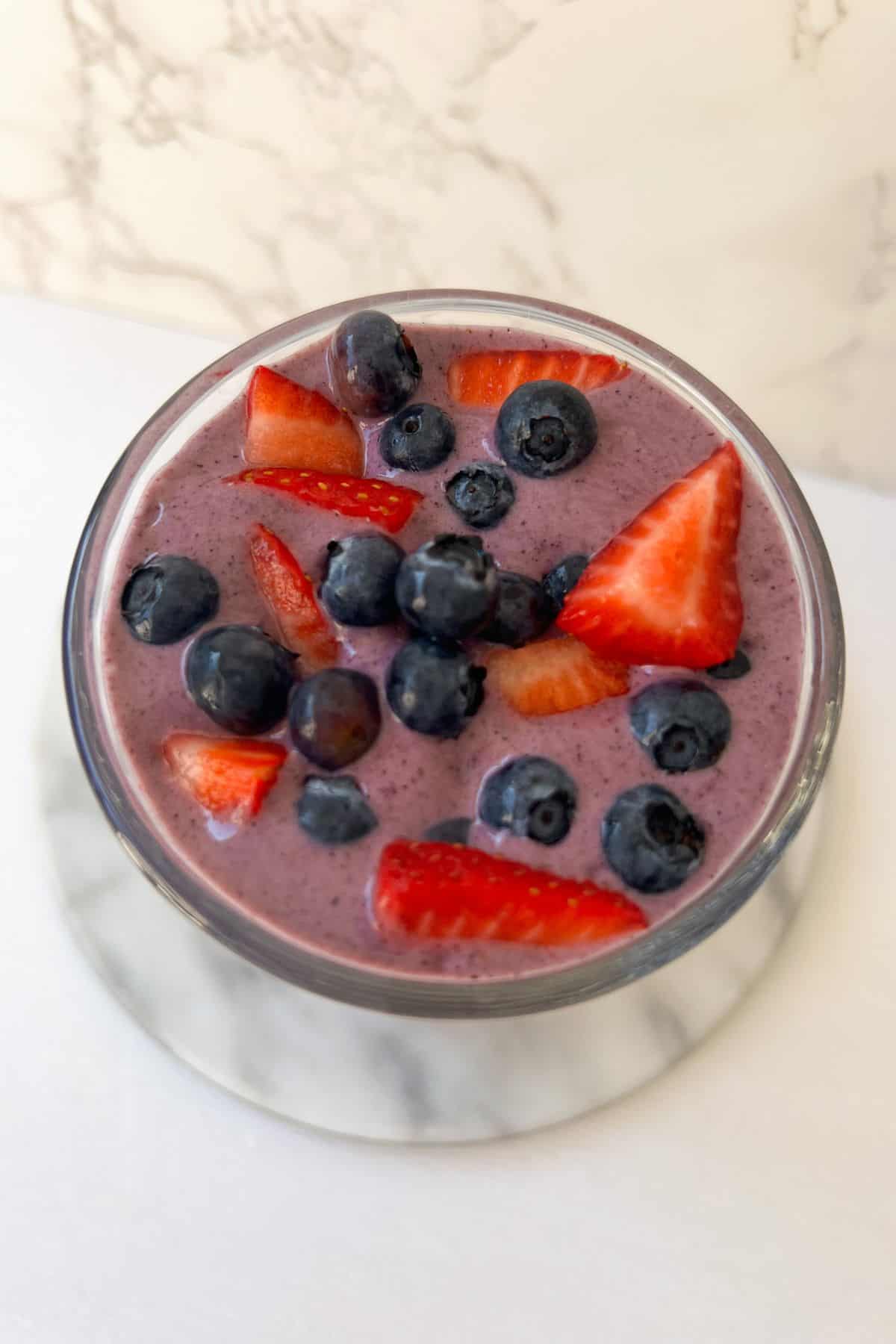 vegan berry smoothie with fresh blueberries and strawberries on top