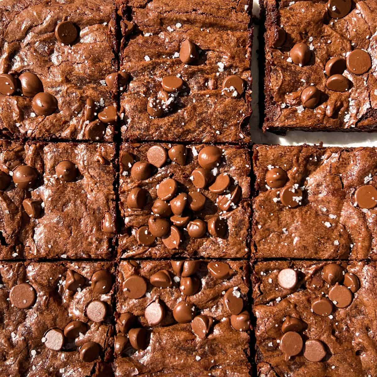 sliced gluten free brownies topped with chocolate chips and sea salt