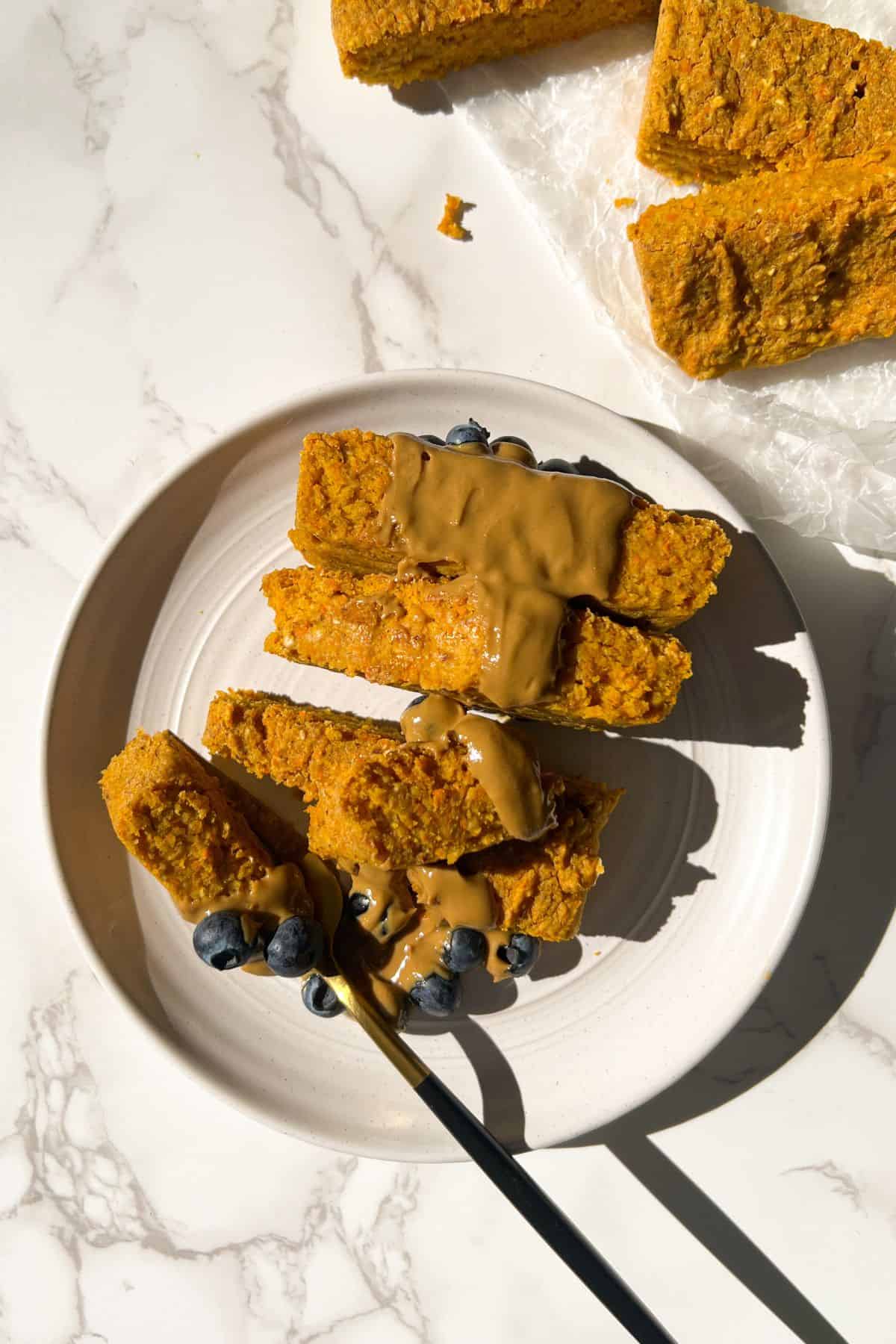 eating carrot cake oatmeal bars with sunflower butter and fresh blueberries