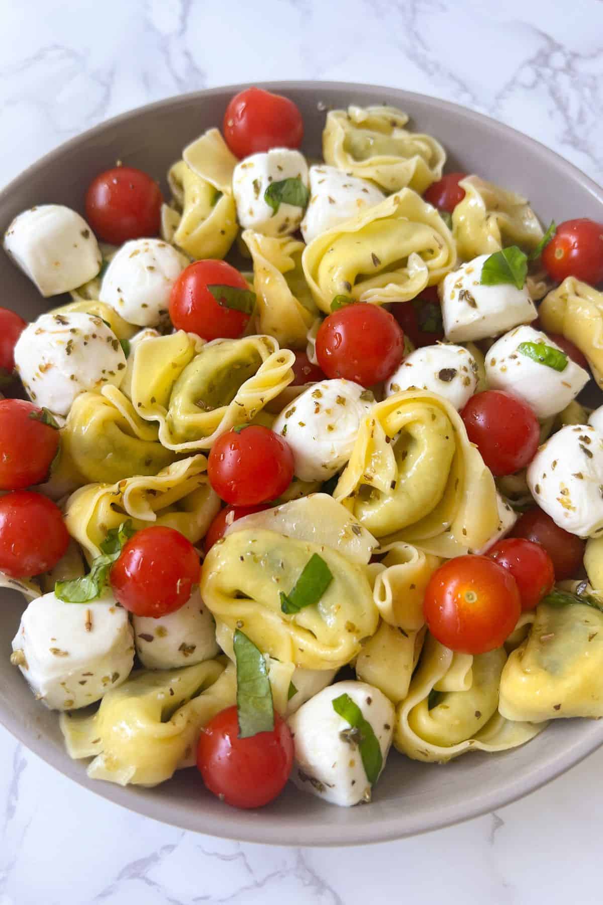 tortellini caprese salad mixed and in a serving bowl