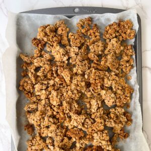chunky gluten free nut free granola on a sheet pan