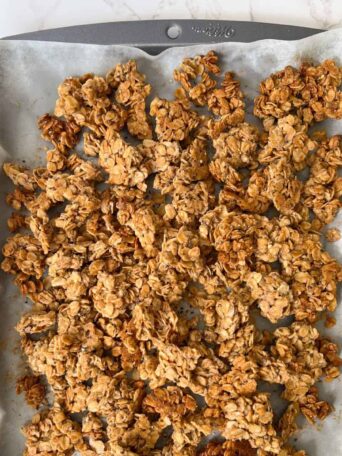 chunky gluten free nut free granola on a sheet pan