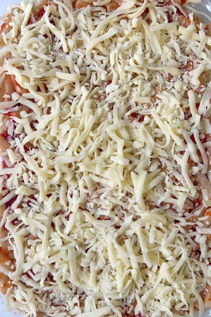 last layer of ziti topped with shredded mozzarella