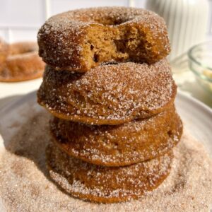 Stack of Gluten Free Apple Cider Donuts coated in cinnamon sugar.