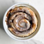 Single Serve Cinnamon in a ramekin and topped with a glaze.