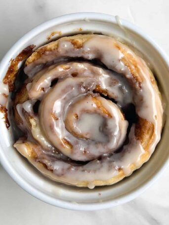 Single Serve Cinnamon in a ramekin and topped with a glaze.