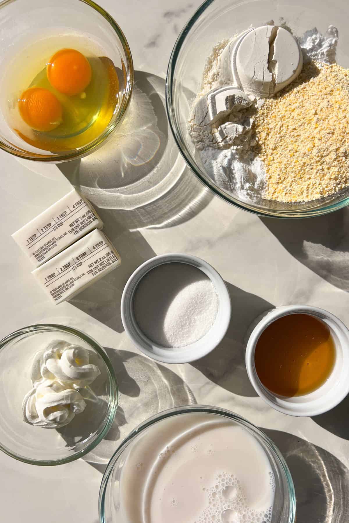 Gluten-Free Cornbread ingredients measured out in glass bowls.