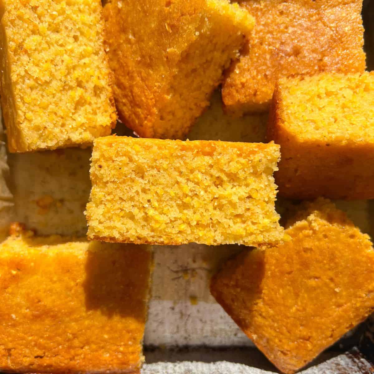 Cut Gluten-Free Cornbread in a baking pan.