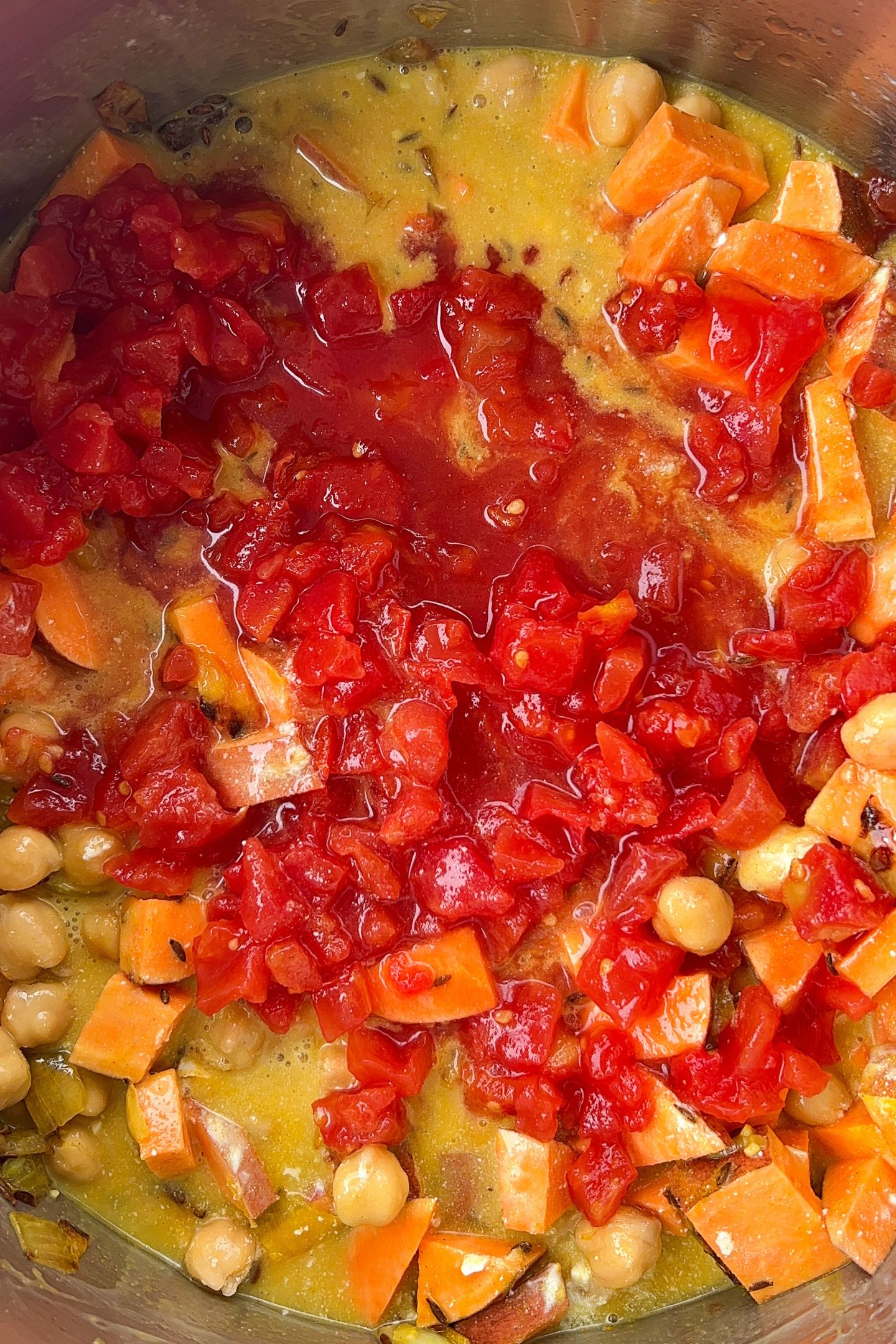 Pour in the entire can of diced tomatoes.